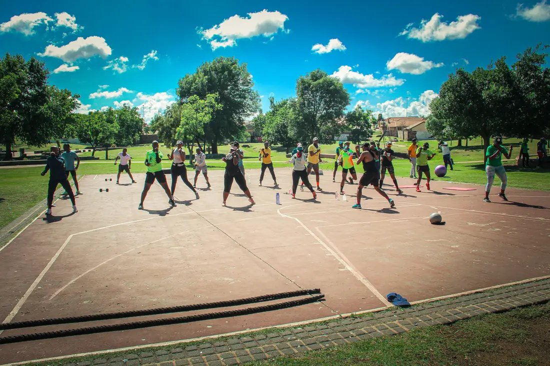 A large outdoor group training session under open sky